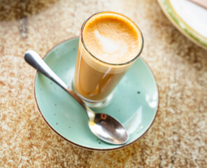 Glass of cortado, coffee beverage with equal parts of steamed milk and espresso