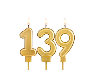 Golden number 139 birthday candle on white background