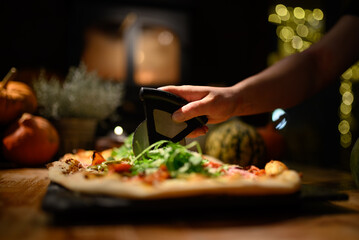 Using a Pizza Cutter to Slice Through a Crispy, Authentic Sourdough Pizza: Perfectly Golden Crust and Fresh Ingredients