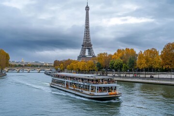 Tourist boat gliding on the seine river in paris with the iconic eiffel tower in the background