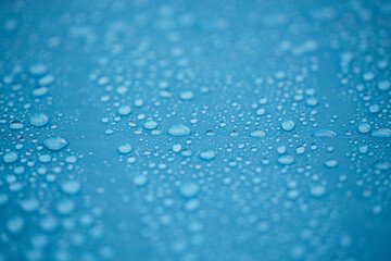 Water drops on waterproof blue tent close up