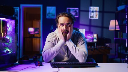 Gamer unhappy with teammates performance while playing esports tournament, struggling to win. Player feeling stressed while competing with friends in multiplayer videogame, frustrated by loss © DC Studio