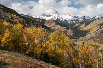 View of snow covered, 13,300 foot Mt. Daly near Snowmass Colorado. A colorful aspen filled valley with dramatic views that are a tourist destination outside the Aspen area. 
