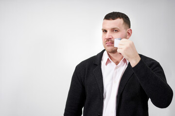 businessman is removing a piece of tape that has been covering his mouth
