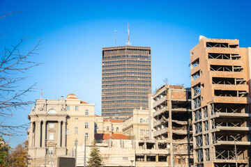 A panoramic view of torn and destroyed buildings alongside modern skyscrapers in the center of Belgrade, Serbia, highlighting the city's reconstruction efforts.
