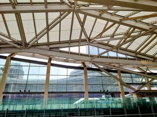 Fototapeta premium Modern architectural structure with glass and steel framework viewed from indoor transit station