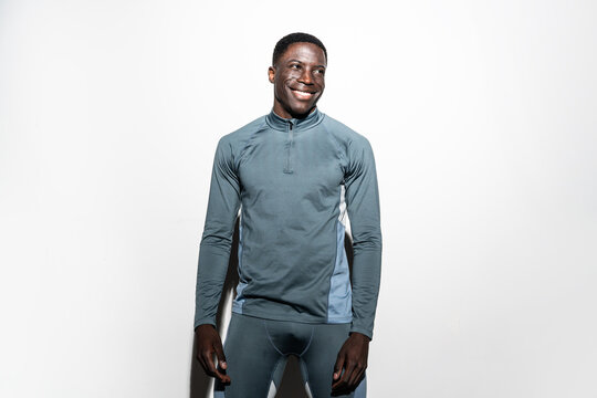 Smiling athletic man in workout clothes with white background