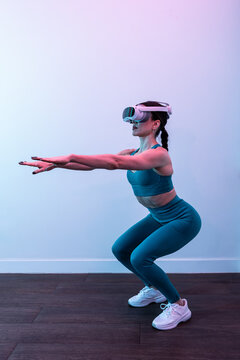 Woman engaged in virtual reality fitness workout wearing VR headset