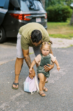 family going to car to leave together