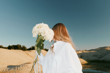 Wedding fashion - Woman in White Outfit Hold Flower 