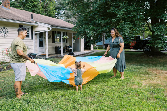 playful happy lgbtq family with mothers and toddler daughters