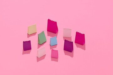 Colorful Paper Gift Bags on Pink Background
