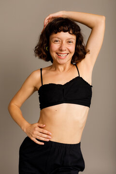 woman posing against grey background