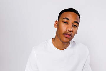 Man wearing white t shirt posing in studio