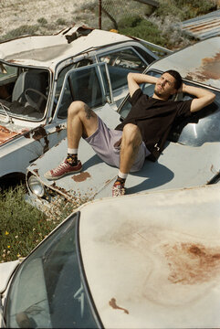 A man sitting on the old trash cars