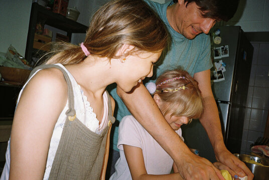 Father and daughters in the kitchen