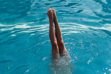 Woman Doing Handstand in a Pool