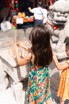 Kids holding Incense Sticks at Chinese Temple