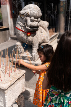 Kids holding Incense Sticks at Chinese Temple