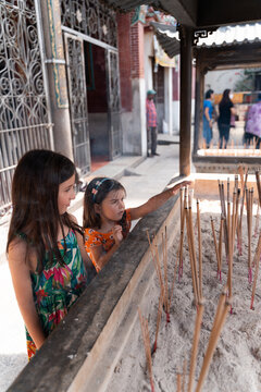 Kids holding Incense Sticks at Chinese Temple