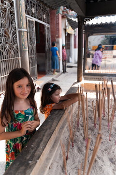 Kids holding Incense Sticks at Chinese Temple