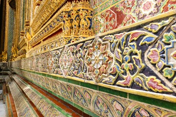 Close-up detail of decorative ceramic tiles around the base of the Phra Ubosot, an ordination hall housing the Emerald Buddha inside Wat Phra Kaew (Temple of the Emerald Buddha) at the Grand Palace, B