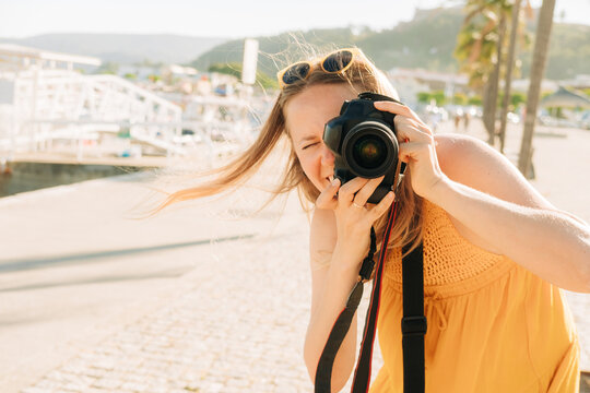 Female tourist photographing during summer vacation
