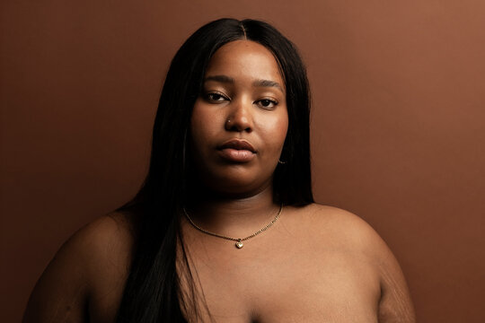 Serious Plus-Size Woman in Minimalist Portrait