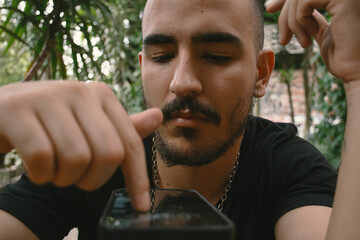 Man Scrolling on Cellphone