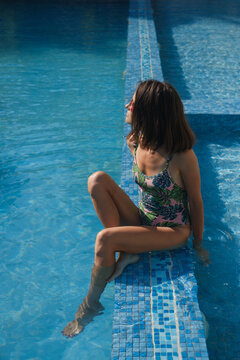 Woman Relaxing at Poolside