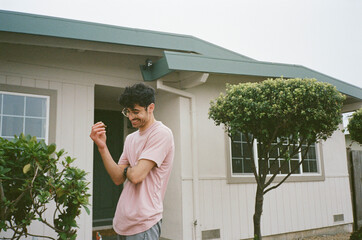 Smiling young man with house keys