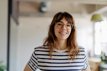 Professional woman smiling in modern office environment