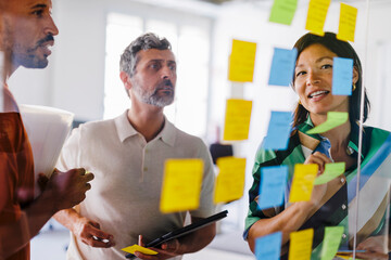 Business team having brainstorming session using adhesive notes