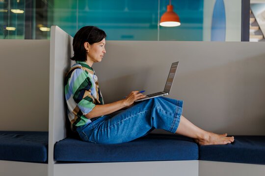 Freelancer woman using laptop computer at modern office