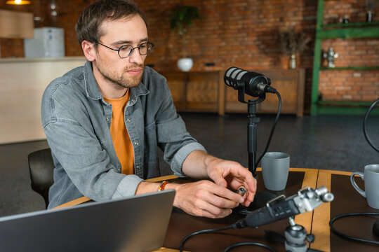 A man is preparing to record a podcast