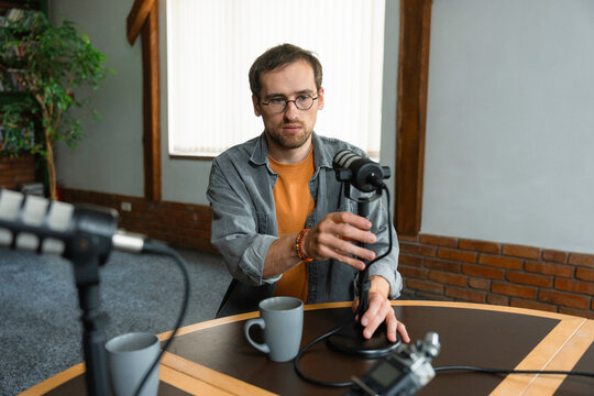 A man is preparing to record a podcast