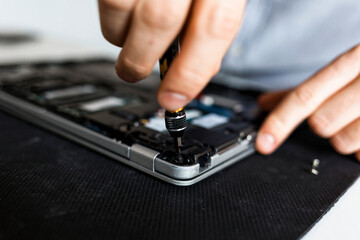 Man repairing a laptop computer
