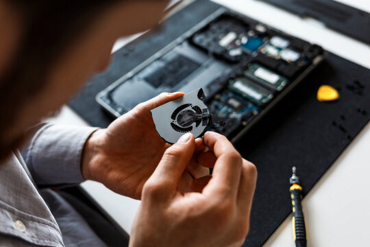 Man repairing a laptop computer