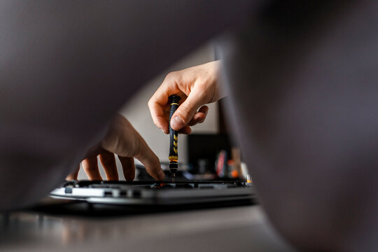 Man repairing a laptop computer