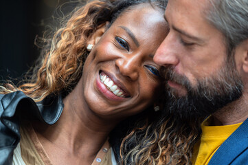 Multiracial couple sharing an affectionate moment outdoors