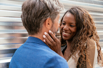 Intimate moment between a diverse couple in urban setting
