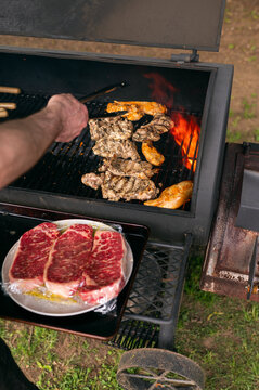 raw chicken cooking on smoker bbq grill