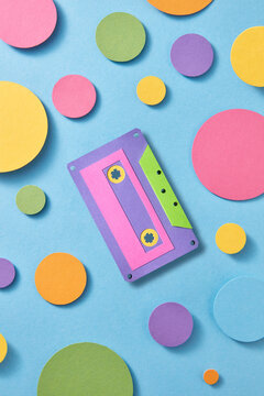 Old audio tape made of paper lying on light blue background