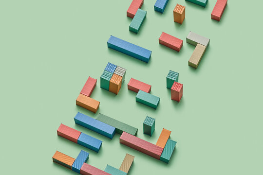 Metal containers in different colours standing in random arrangement