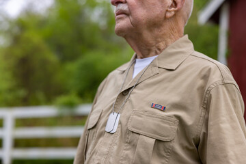 Senior Citizen military War Veteran close up dog tag  