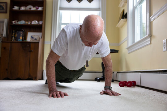 strong Senior Citizen military Veteran doing exercise push up 