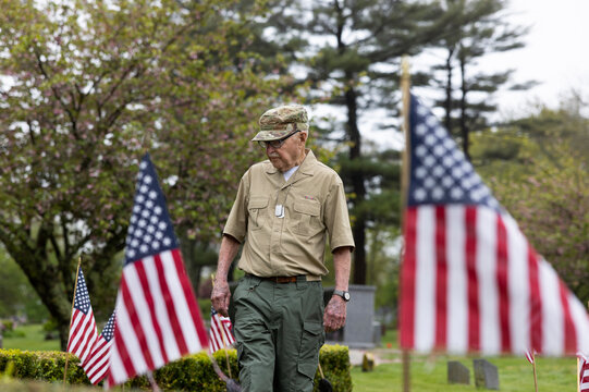 Veteran American flag honor at grave cemetery