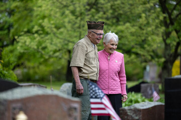 Senior military War Veteran holding wife on memorial day event