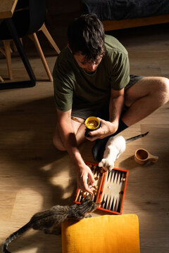Man Eating Noodles Relaxed on Floor
