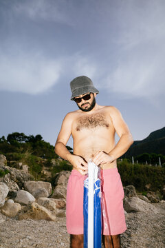 Man Setting Up Beach Umbrella
